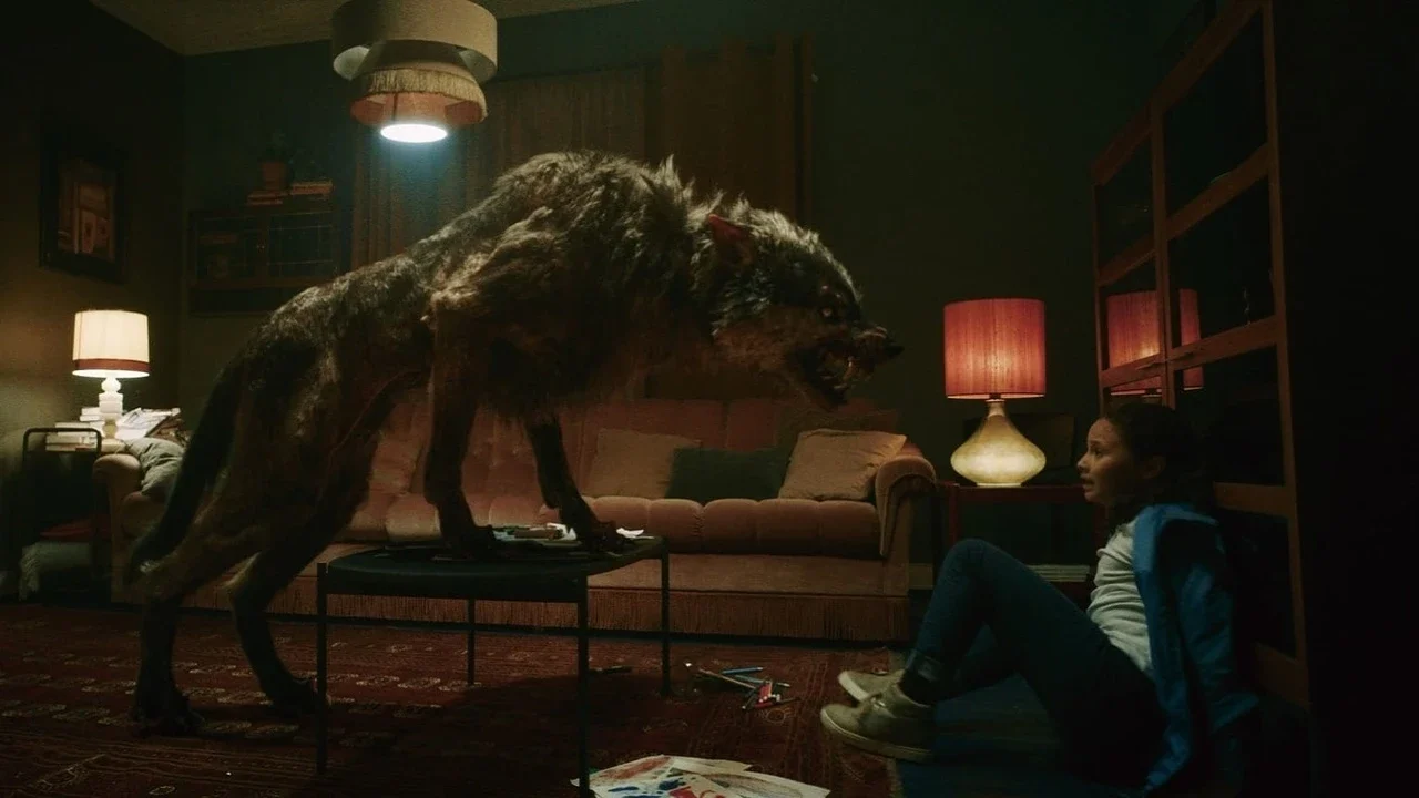 Still from the film Viking Wolf, in which a huge wolf lunges at a little girl over a living room table